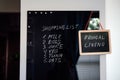 Frugal living, save money, live cheap concept with shopping list on letterboard and Frugal living text in frame in