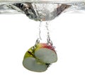 Fruit apple is dropped into water