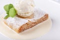 Fruit apple strudel cake served with ice cream, mint leaf and vanilla sauce. Classical austrian dessert on white plate Royalty Free Stock Photo