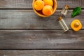 Fruit aroma oil. Apricot kernel oil on dark wooden background top view frame space for text Royalty Free Stock Photo