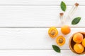 Fruit aroma oil. Apricot kernel oil on white wooden background top view frame space for text Royalty Free Stock Photo