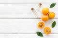 Fruit aroma oil. Apricot kernel oil on white wooden background top view frame copy space Royalty Free Stock Photo