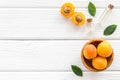 Fruit aroma oil. Apricot kernel oil on white wooden background top view frame copy space Royalty Free Stock Photo