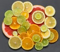 Fruit background. Sliced citrus fruit on a stone table. Top view. Juicy ripe orange, tangerine, grapefruit, lime and lemon on a Royalty Free Stock Photo