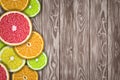 Fruit background with slices of orange, grapefruit, lemon and lime on wooden desk.