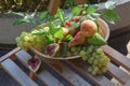 Fruit basket. Grapes, figs, peaches and pears in a wicker basket