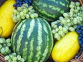 Fruit basket with melon, watermelon grapes,on straw Royalty Free Stock Photo