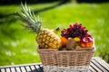 Fruit basket on table, green background Royalty Free Stock Photo