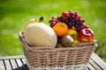 Fruit basket on table, green background Royalty Free Stock Photo