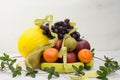 Fruit basket on white background with apple, pear melon grapes orange banana measuring tape Royalty Free Stock Photo