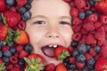 Fruit berry, kids face with fruit. Funny fruits. Kids face with berries mix of strawberry, blueberry, raspberry Royalty Free Stock Photo