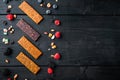 Fruit berry and nut energy bars, healthy snack, top view with copy space, on black wooden table Royalty Free Stock Photo