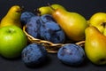 Fruit on a black background. Plums, pears and apples lie side by side. Royalty Free Stock Photo