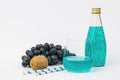 Fruit, bottle and cocktail glass on a light background