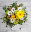 Fruit bouquet with apples, yellow flowers, kiwi fruit and avocado.