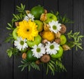 Fruit bouquet with apples, yellow flowers, kiwi fruit and avocado.