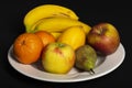 Fruit bowl with bananas, oranges, apples, lemon and pear Royalty Free Stock Photo