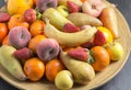 Fruit bowl with exotic whole fruits close up in rustic wooden bo Royalty Free Stock Photo