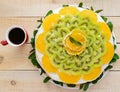 Fruit cake (orange, kiwi, mint) with a white cup Royalty Free Stock Photo