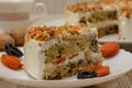 Fruit cake, a piece on a plate with dried fruits. Wood background