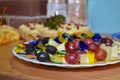 Fruit canape with colorful plastic heart skewers on cocktail or a buffet table