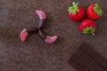 Fruit candy dipped in chocolate, together with a chocolate bar a