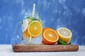 Fruit cocktail with lemon, orange and mint. Glass jar and tubule