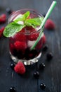 Fruit coctaile and color berries on natural dark wooden desk