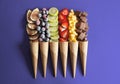 Fruit cones in purple background