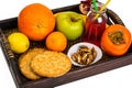 Fruit, cookies, nuts, wooden tray, white background Royalty Free Stock Photo