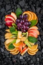 fruit cuts dish with apples oranges kiwi pineapple grapes with mint Royalty Free Stock Photo