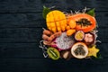 Fruit dragon, papaya, maracuya, kiwi, mango and granadilla in a wooden box. Fresh Tropical Fruits.