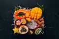 Fruit dragon, papaya, maracuya, kiwi, mango and granadilla in a wooden box. Fresh Tropical Fruits.