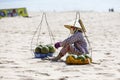 Fruit and drink seller sit on sandy beach in Nam Tien, Vietnam Royalty Free Stock Photo