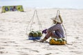 Fruit and drink seller sit on sandy beach in Nam Tien, Vietnam Royalty Free Stock Photo