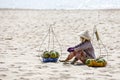 Fruit and drink seller sit on sandy beach in Nam Tien, Vietnam Royalty Free Stock Photo