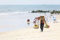 Fruit and drink seller walk in a beach in Nam Tien, Vietnam Royalty Free Stock Photo