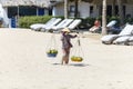 Fruit and drink seller walk in a beach in Nam Tien, Vietnam Royalty Free Stock Photo