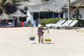 Fruit and drink seller walk in a beach in Nam Tien, Vietnam Royalty Free Stock Photo