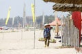 Fruit and drink seller walk in a sandy beach in Nam Tien, Vietnam on February 15, 2018 Royalty Free Stock Photo