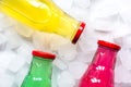 Fruit drinks in colorful plastic bottles with ice top view mock-up Royalty Free Stock Photo
