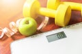 Fruit, dumbbell and scale, fat burn and weight loss Royalty Free Stock Photo