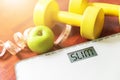 Fruit, dumbbell and scale, fat burn and weight loss concept, Royalty Free Stock Photo