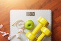 Fruit, dumbbell and scale, fat burn and weight loss concept Royalty Free Stock Photo