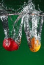 Fruit falling into water Royalty Free Stock Photo