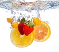 Fruit falling into water Royalty Free Stock Photo