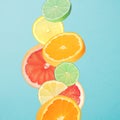 Fruit that falls. Slices of orange, grapefruit, lemon and lime. Blue background. Royalty Free Stock Photo