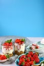 Fruit. Fresh red strawberries on old wooden background candy bar. Healthy layered dessert with cream, muesli isolated on a blue ba Royalty Free Stock Photo