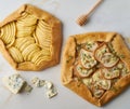 Fruit galette, apple pie with honey, savory pear and cheese pie, marble table, top view Royalty Free Stock Photo