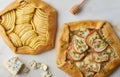 Fruit galette, apple pie with honey, savory pear and cheese pie, marble table, top view, close up Royalty Free Stock Photo